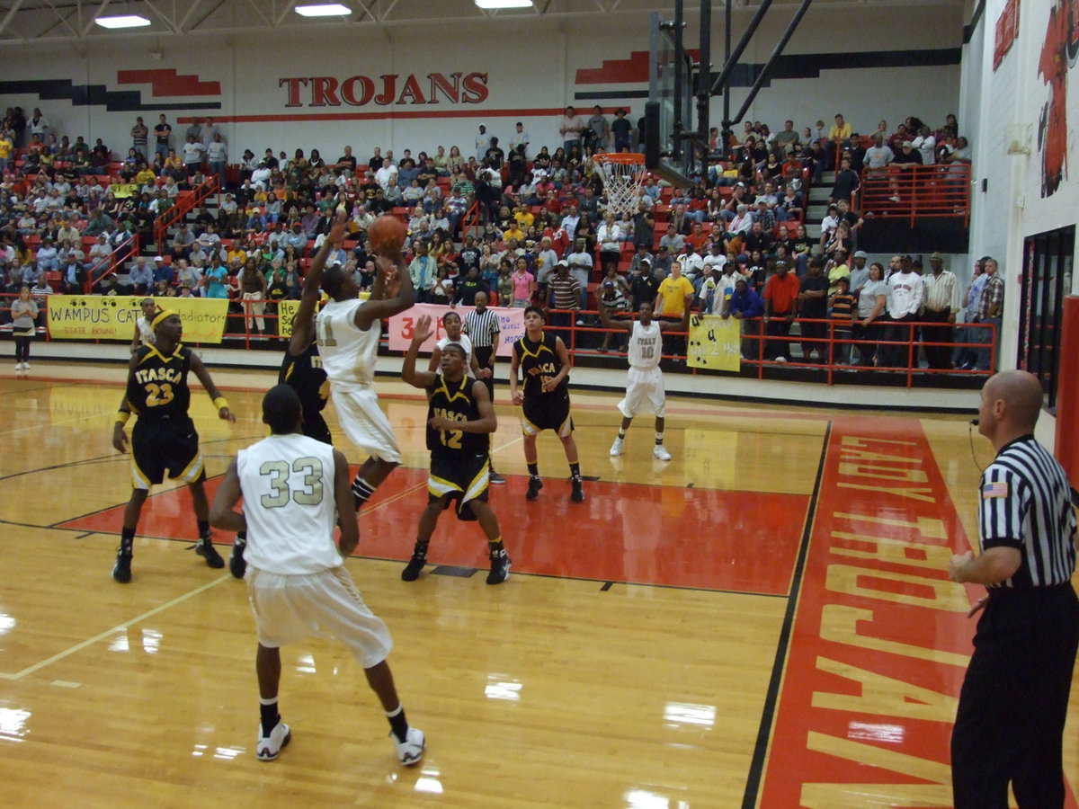 Image: Anderson Avoids — Jasenio Anderson #11 avoids the paw of an Itasca defender as he goes up for 2 of his 26-points.