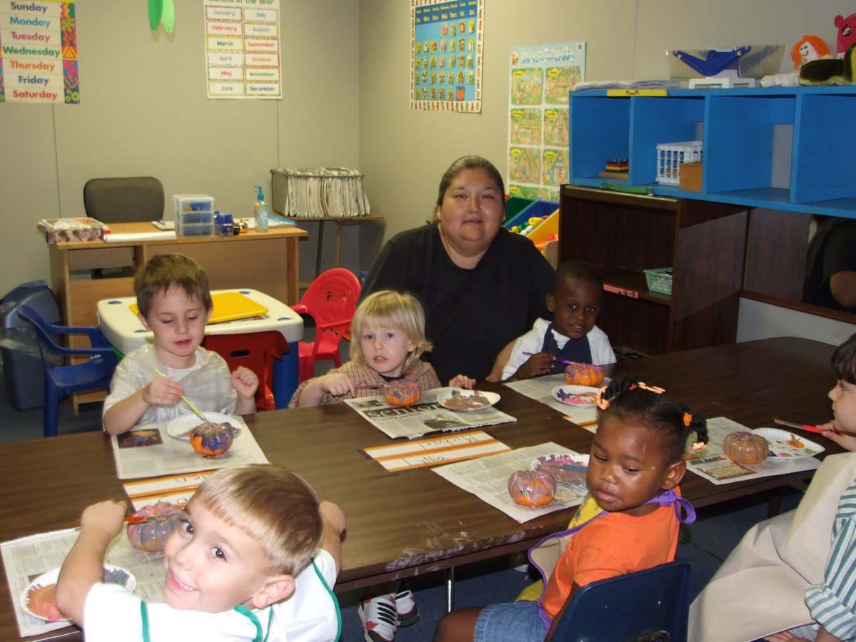 Image: Italy Daycare class - This is the three and four-year-old class at Italy Daycare Center having a great time painting pumpkins.