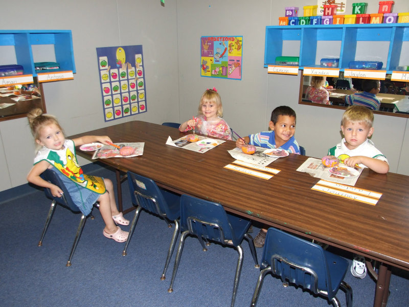 Image: Three and four year olds. - These cute pumpkin painters are part of the three and four-year-old class.