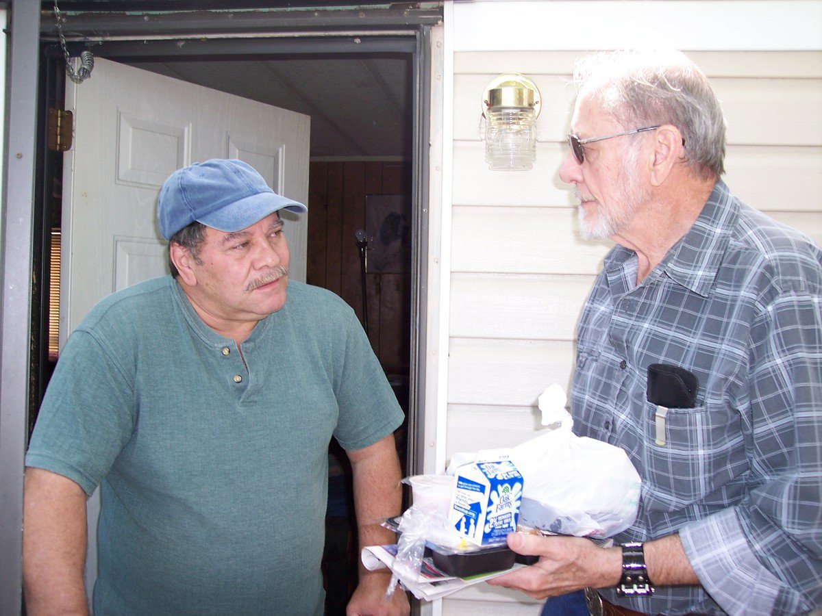 Image: Volunteer Louis Sherwood — Bryan Bird chats about gardening with volunteer, Louis Sherwood