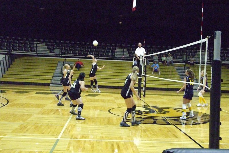 Image: Windham jumps — Junior Drew Windham has high jumps for the score.