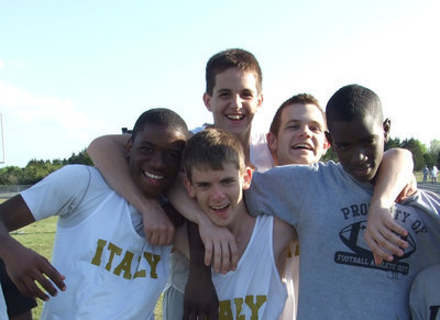 Image: Miles and smiles — These 7th and 8th grade boy tracksters are all smiles before they run their miles.