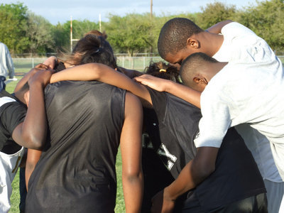 Image: Taking a moment… — Some members of the Italy Junior High Track Team huddle up for strength.