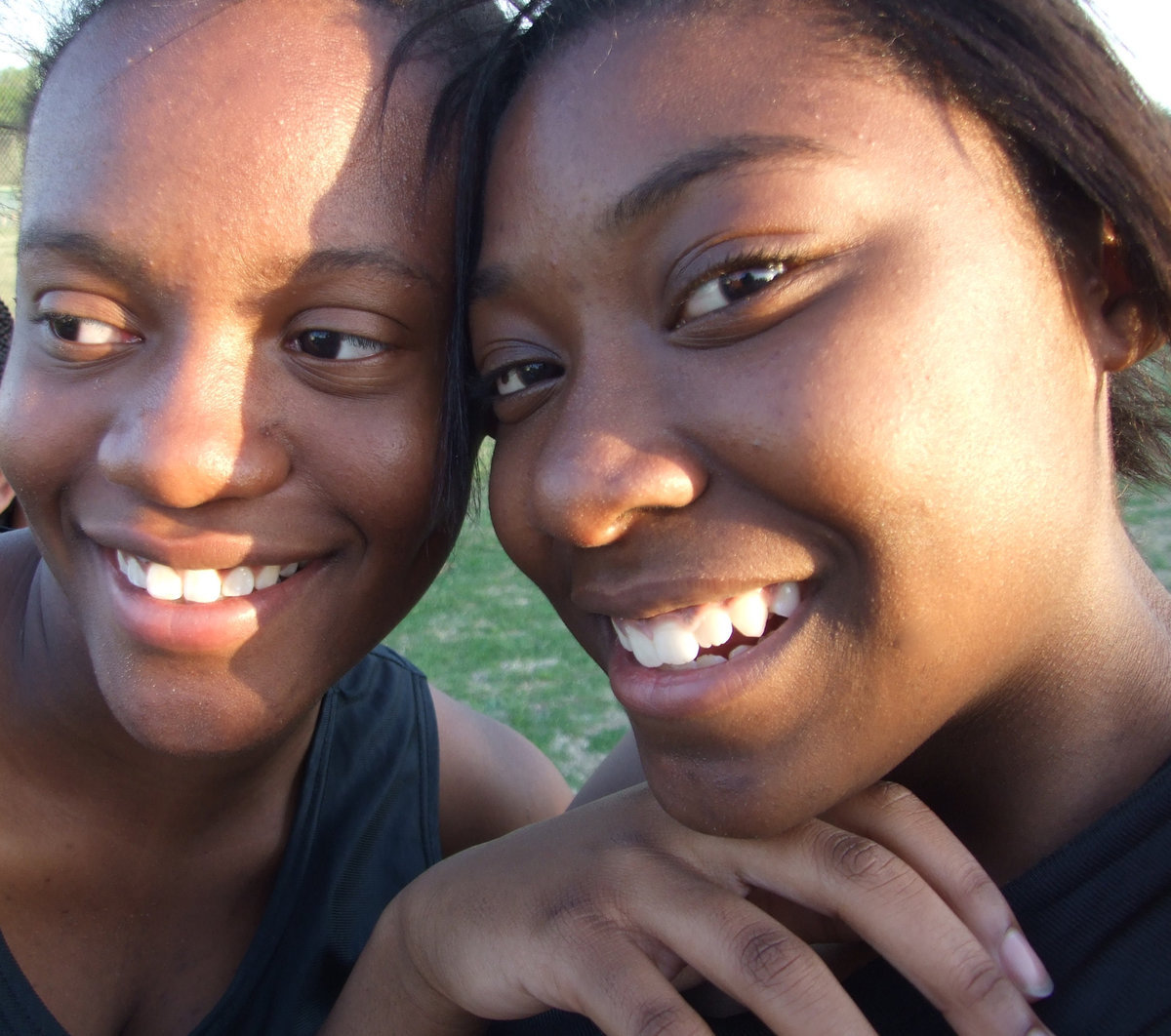 Image: Brianna and Jameka — Brianna Burkhalter and Jameka Copeland try to stay warm for their races on a breezy night in Hubbard.