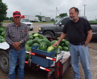 Image: I’ll take this one…no…this one! — Rory Reeves tries to pick out the perfect watermelon with the assistance of Luciano Garza, the watermelon wizard.