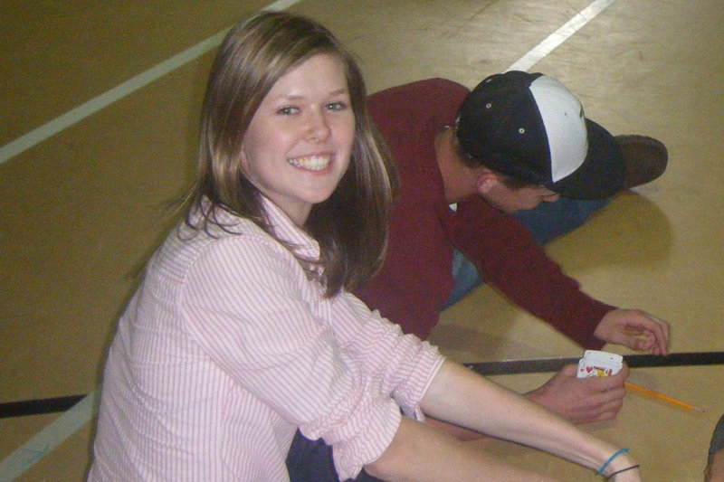 Image: Waiting on their event — Students play a quick game of cards while waiting on their events.