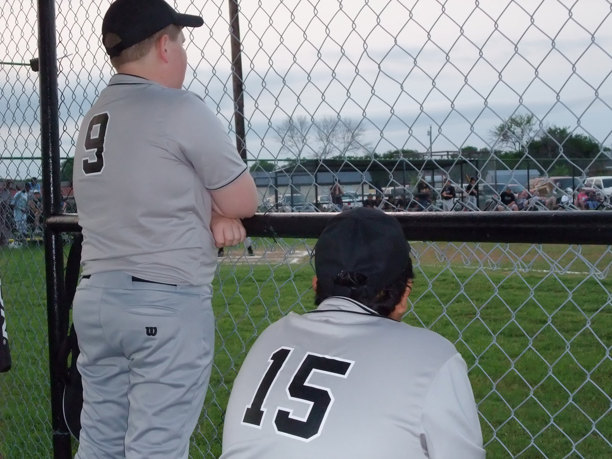 Image: Cage match! — Russel Clingenpeel and Victor Desmond peer through the cage to watch the battle.