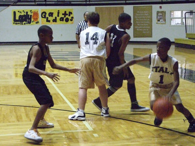 Image: Carson off the screen — Eric Carson #1 gets some help from his teammate as he drives toward the paint.