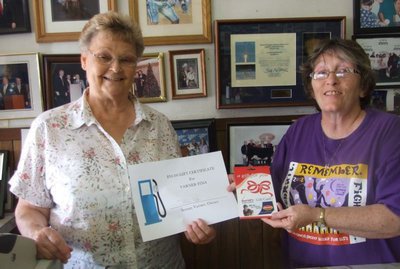 Image: Gift cards winner — Karen Mathiowetz (right) presents the gift cards to prize winner Doris Mitchell.