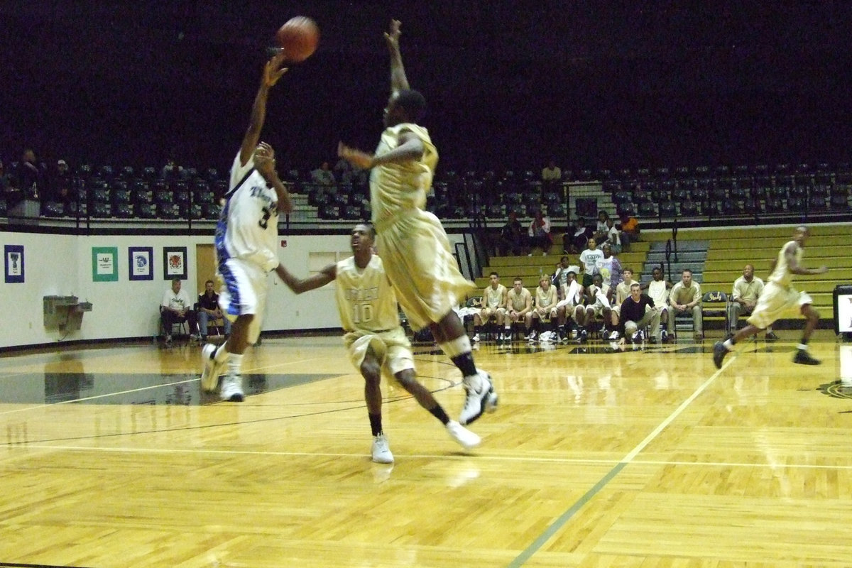 Image: Jasenio Jumps — Jasenio Anderson forces an overthrown pass by Trinity Christian.