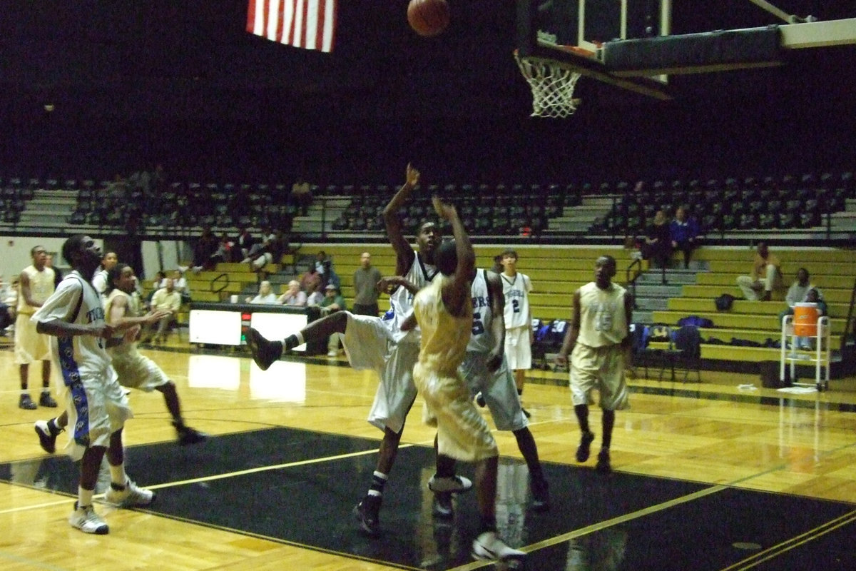 Image: A Tiger Pounces — A Trinity Christian defender goes for the shot block.