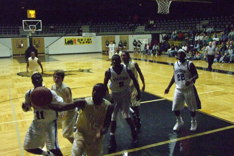 Image: Saving The Ball — Italy tries to keep the ball in play and score a bucket against the Trinity Christian defense.