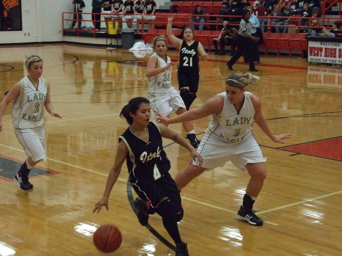 Image: Perez pushes — Marisela Perez pushes the ball up the floor for the Lady Gladiators.