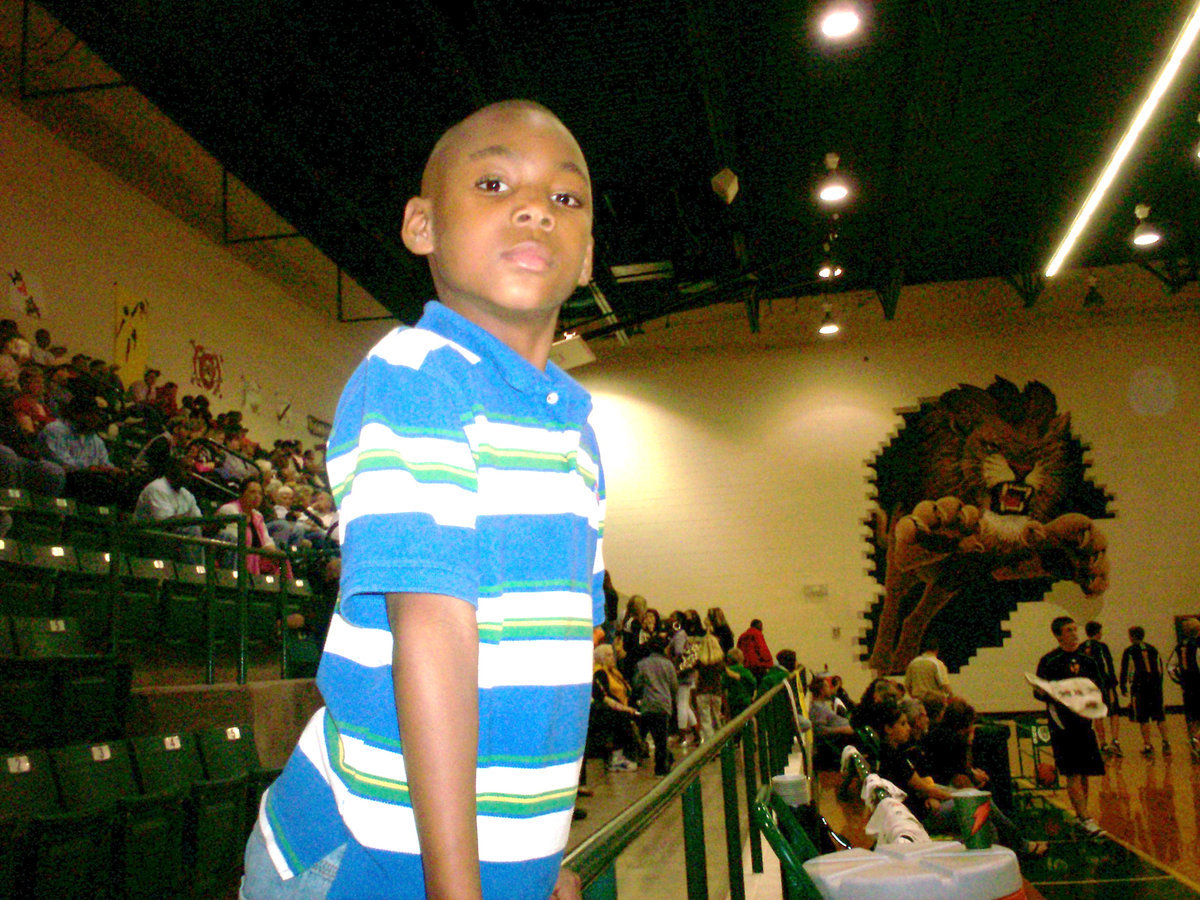 Image: Taking it all in — This future Gladiator absorbs the moment hoping to get his shot at State someday.