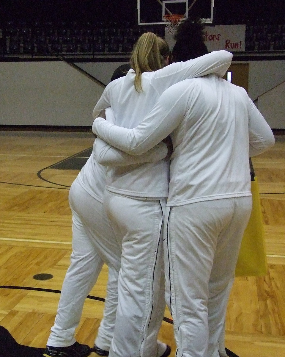 Image: Told ya so — A tearful Becca DeMoss is hugged by teammates, Kyonne Birdsong and Jimesha Reed, as she heads for the locker room. The Lady Gladiators dried their tears and handed Dallas Faith Family a 45-43 loss.