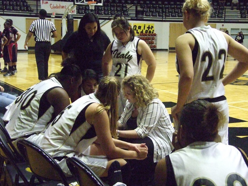 Image: Senior’s last huddle — Senior players #21 Blanca Figueroa and #5 Becca DeMoss remain alert in their final huddle inside the Italy Coliseum.