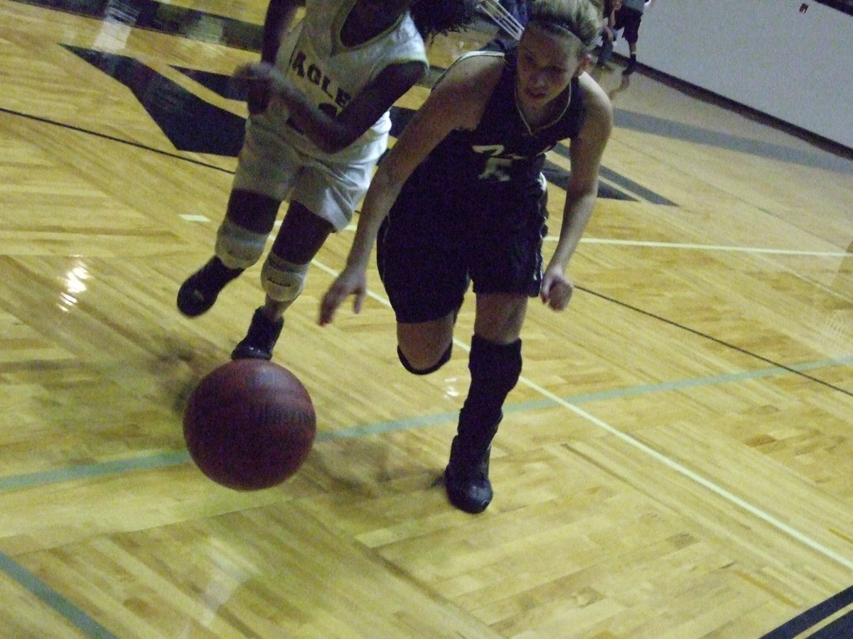 Image: Becca scrambles — DeMoss prepares to dive for the loose ball.