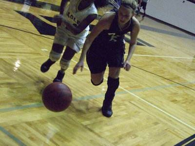Image: Becca scrambles — DeMoss prepares to dive for the loose ball.