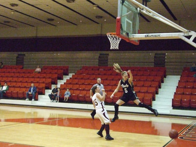 Image: DeMoss Goes Airborne — On a fast break, Italy’s #5 Becca DeMoss has the ball slapped away at the last moment by a Mildred defender.