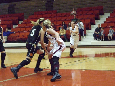 Image: DeMoss Penetrates — Senior point guard #5 Becca DeMoss puts it on the floor trying to get to the rim.
