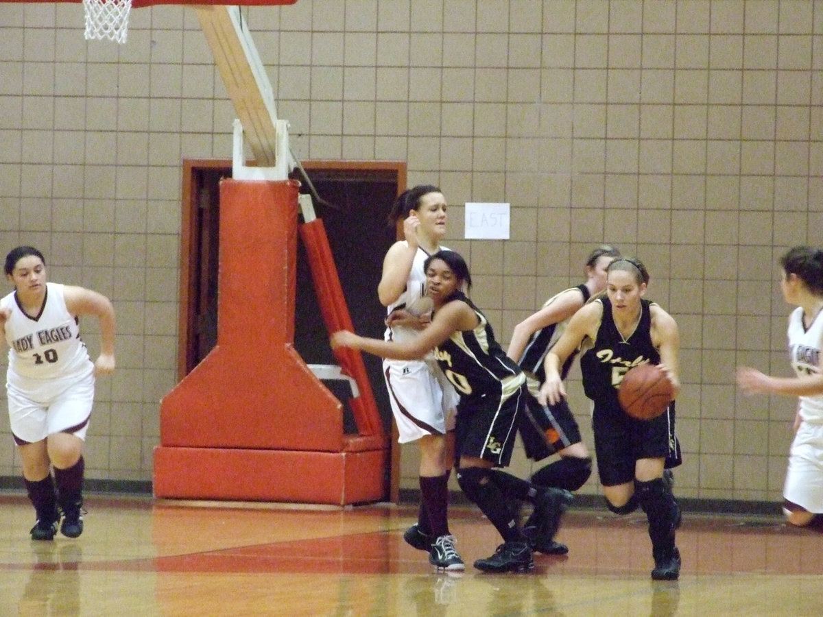 Image: Here Come The Lady Gladiators — DeMoss pushes the ball up the court and into the Consolation Championship game.