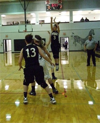 Image: Jump shooter — Lady Gladiator Kaitlyn Rossa(3) shoots the long ball with teammate Bailey Bumpus(13) looking on.