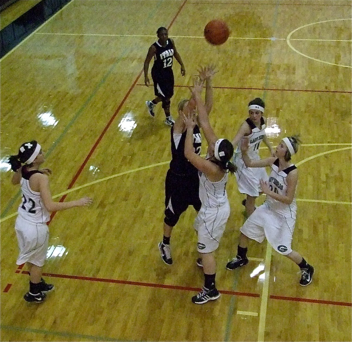 Image: Megan shoots — Lady Gladiator Megan “Rich” Richards(22) puts up a shot over three Zebra defenders.