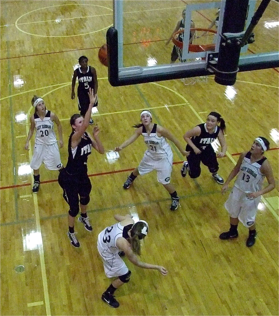 Image: Kaitlyn inside — Lady Gladiator Kaitlyn Rossa(3) finds room in the paint to put up a shot over the Zebra defense as Shelbi Gilley(4) hustles in to help.