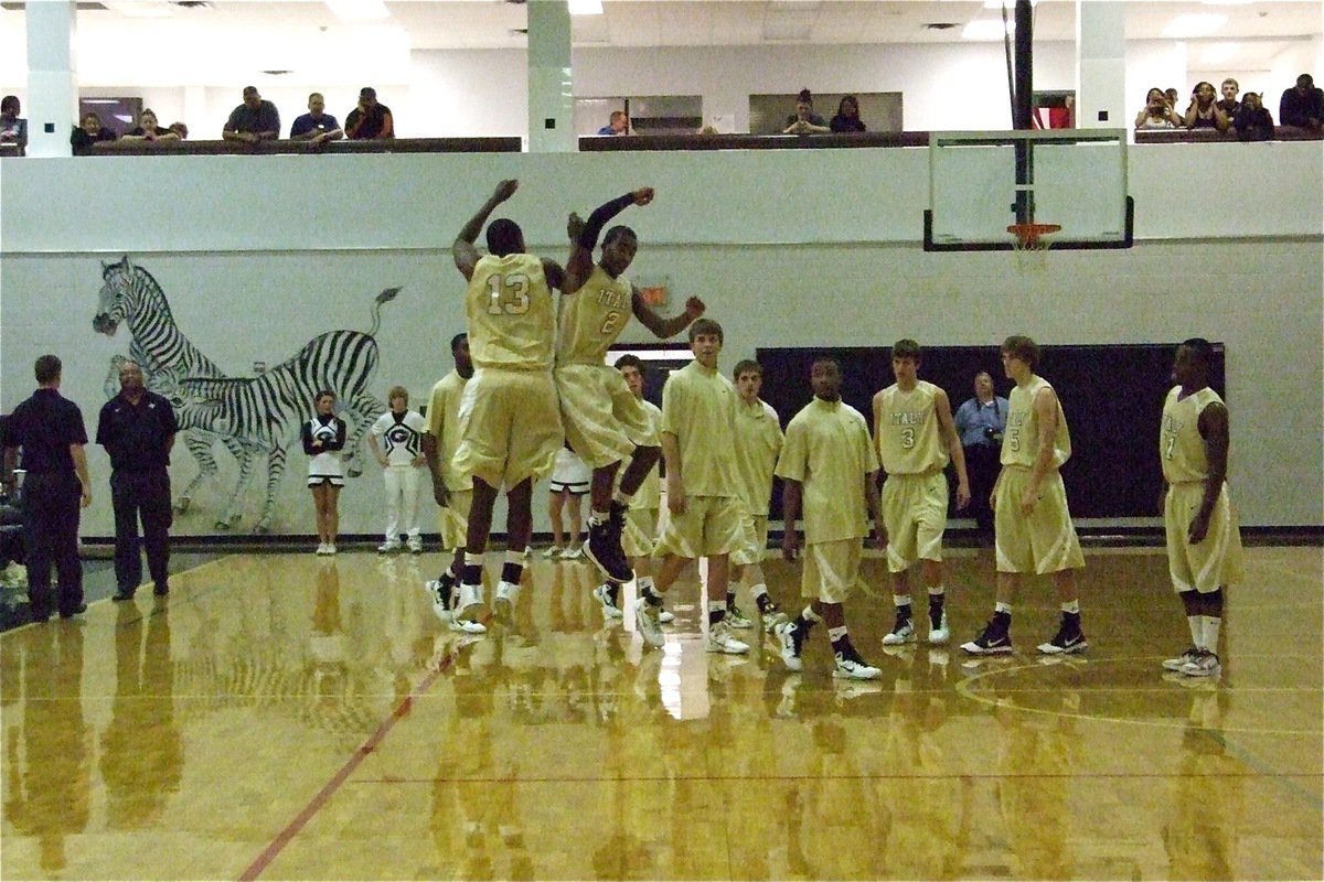 Image: Here we go! — Larry Mayberry, Jr.(13) and Heath Clemons(2) do an aerial bump to get fired up for the Zebras during the pre-game introductions.