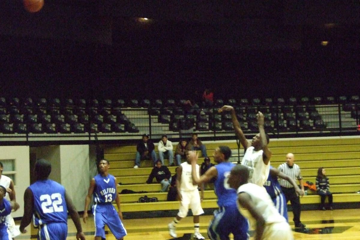 Image: John Isaac Shoots — John Isaac #10 fires a jumper against Milford trying to help the Gladiator’s cause.