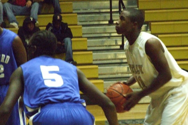 Image: Eyeing The Goal — Jasenio Anderson #11 attempts a free throw against the Bulldogs.