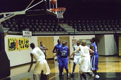 Image: Heath Clemons Shoots — Heath Clemons #2 floats up a shot as Donald Walton #21 moves in for a rebound.