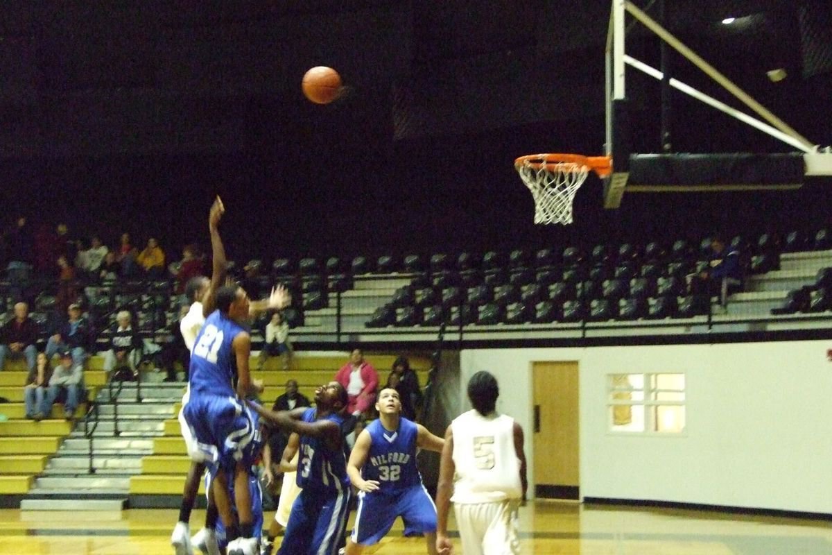 Image: Contested Shot — Milford’s #21 tries to block a shot attempt by the Gladiators in the second half.