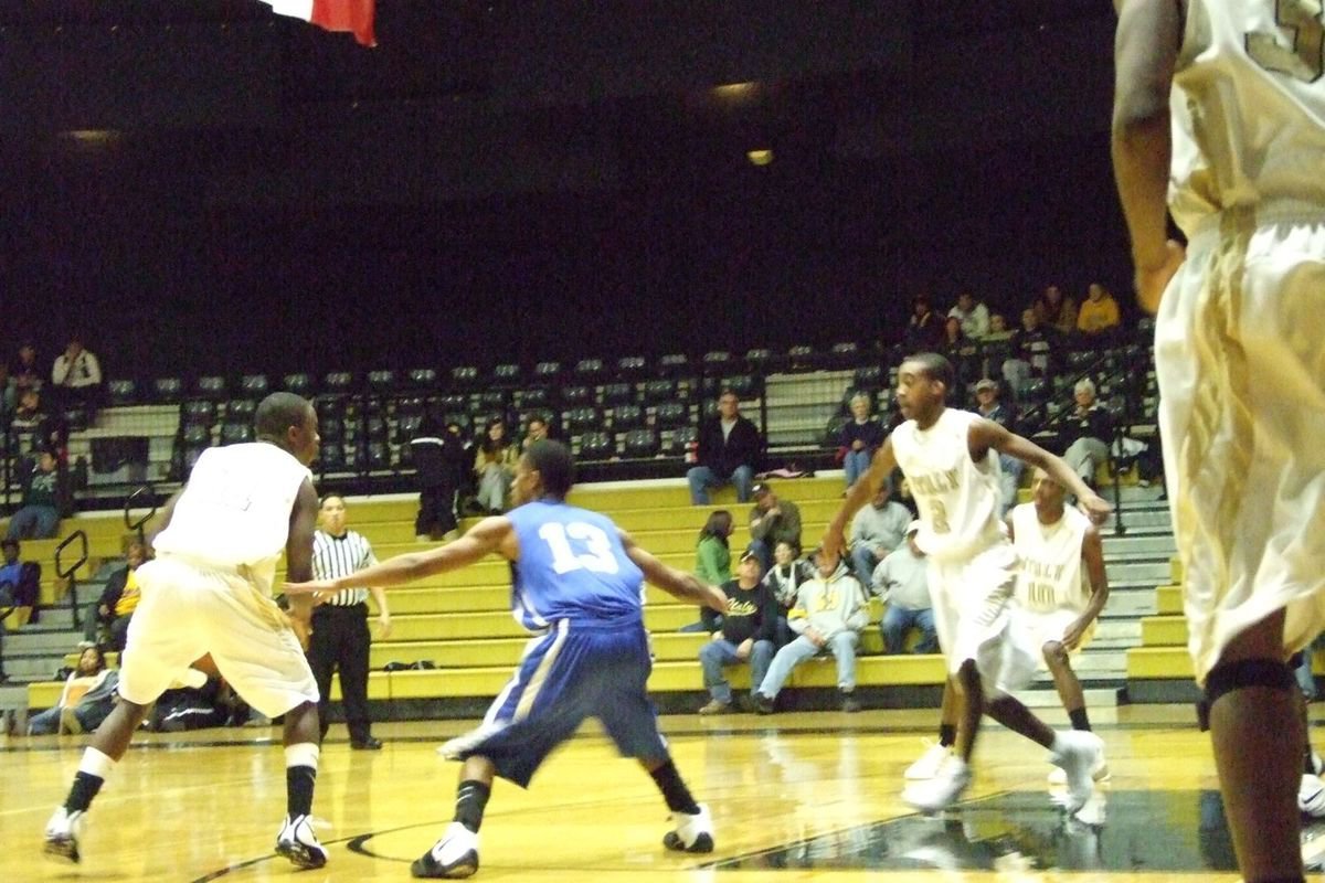 Image: Setting Up The Offense — Heath Clemons #2 prepares to set a screen hoping to free up his teammate Jasenio Anderson #11.