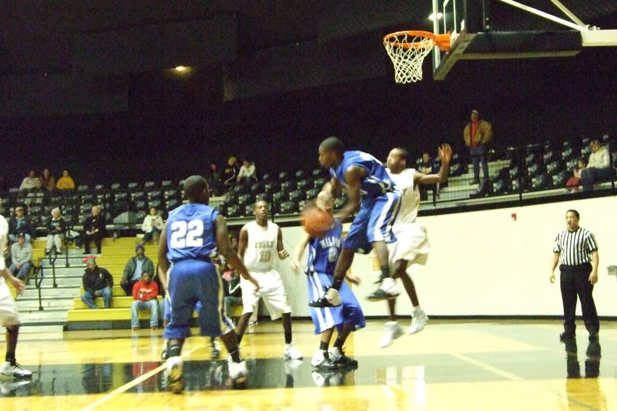 Image: Leaps And Bounds — A Milford defender leaps and rebounds the ball away from attacking Gladiators.