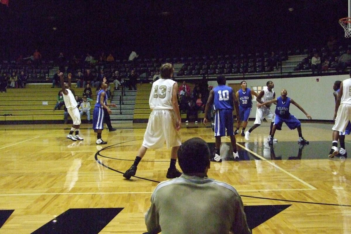 Image: Anderson From Deep — Italy’s Jasenio Anderson attempts a 3-point shot against the Bulldogs as Coach Holley observes.