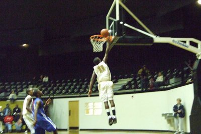 Image: The Sophomore Sensation — Flying in for a layup is Jasenio Anderson #11 helping to seal the Gladiator’s victory.