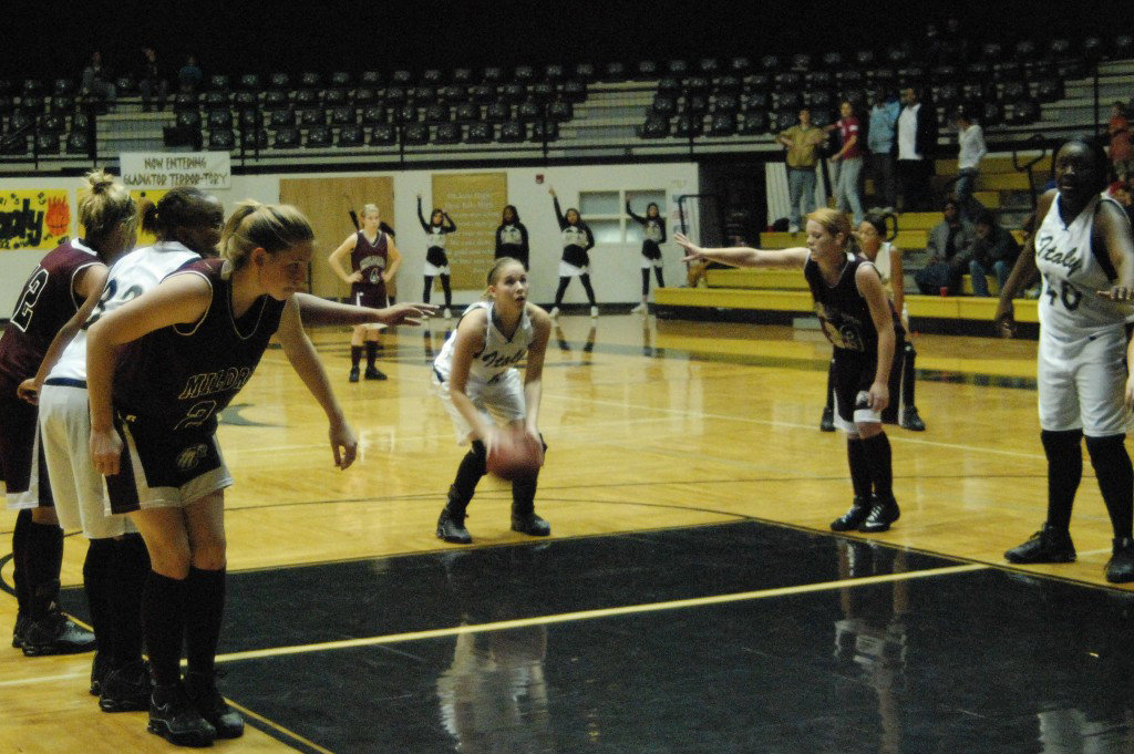 Image: Becca DeMoss Concentrates — Senior Captain, Becca DeMoss gets set to make a free shot as Junior #32 Shay Fleming and Freshman #40 Jimesha Reed get ready to fight for the rebound.