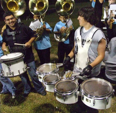 Image: Perez enjoys music — Mr. Perez takes a minute and plays the drums with senior, Trevor Davis, during one of the football games.