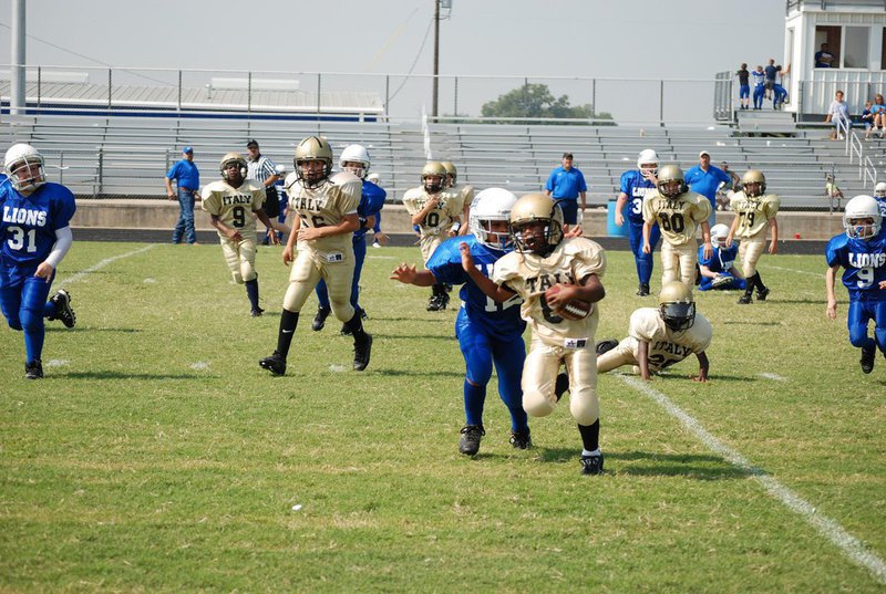 Image: Fending off the tackle — The offense kept running for the score on Saturday.