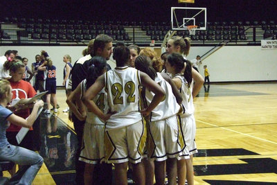 Image: Lady Glads Huddle Up — Coach Coker gives the 8th grad girls plays for the next half.