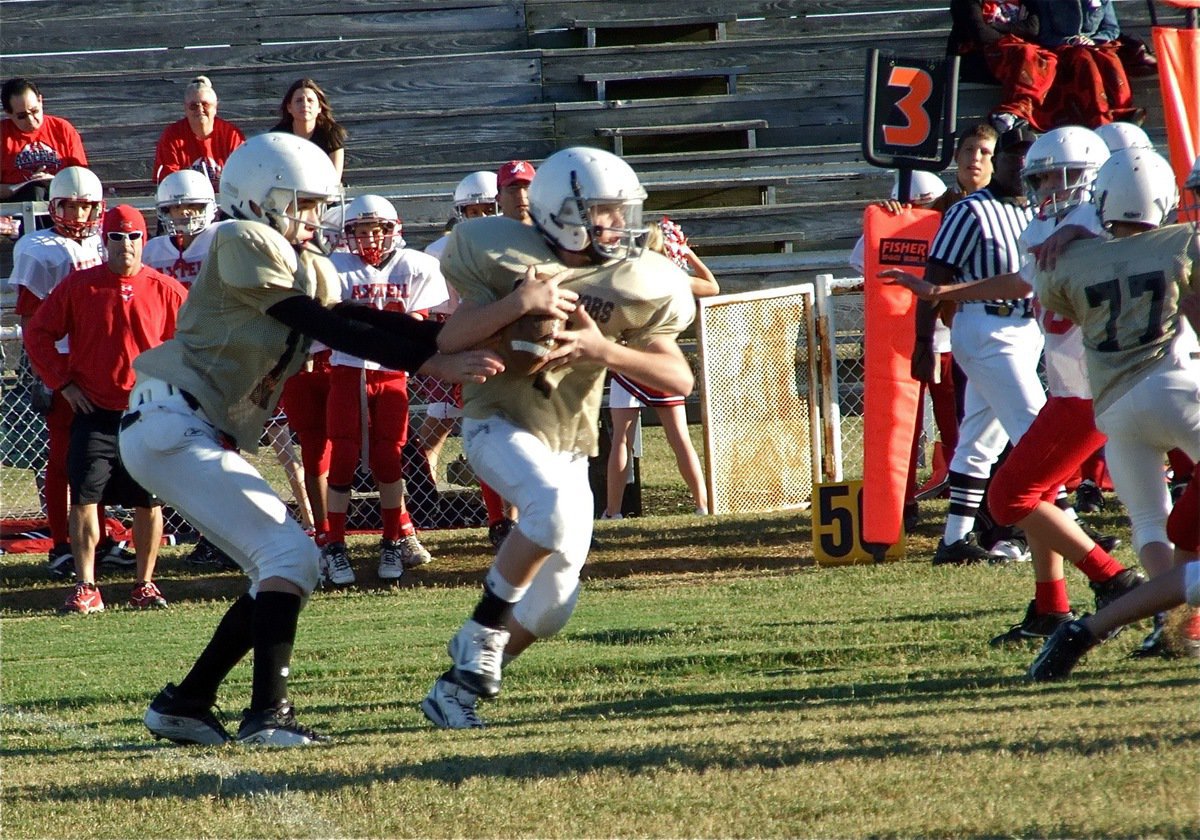 Image: Give and go! — Quarterback Ryan Connor(17) hands off to John Escamilla(7) who tries to take the bull by the Longhorns.