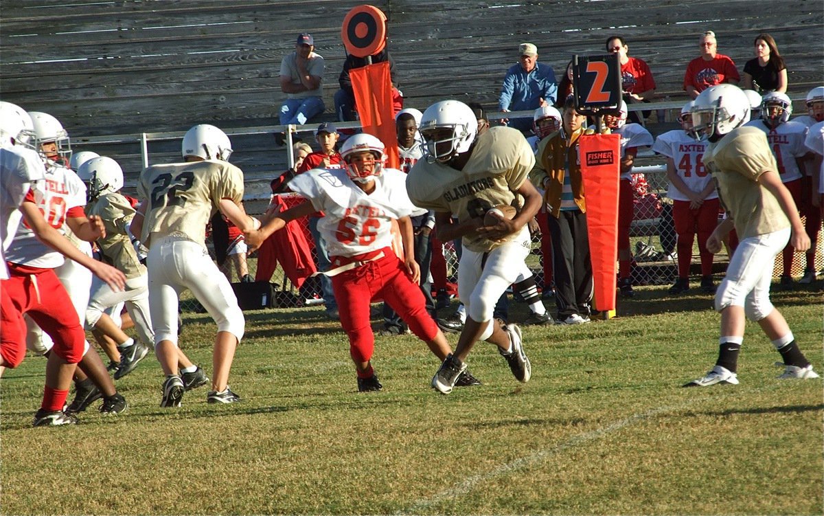 Image: JaRay is gone — John Escamilla(7) hands to JaRay Anderson(9) who runs left for several yards against the Axtell Longhorns.