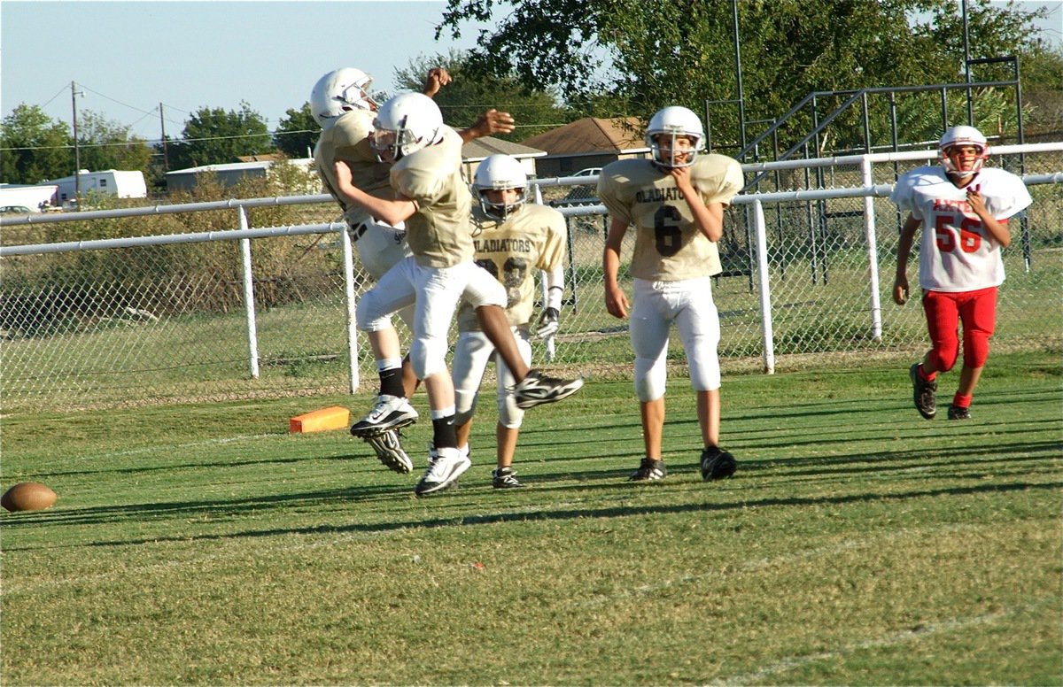 Image: The fun part — JaRay Anderson(9) and John Escamilla(7) jump for joy after an Anderson touchdown.