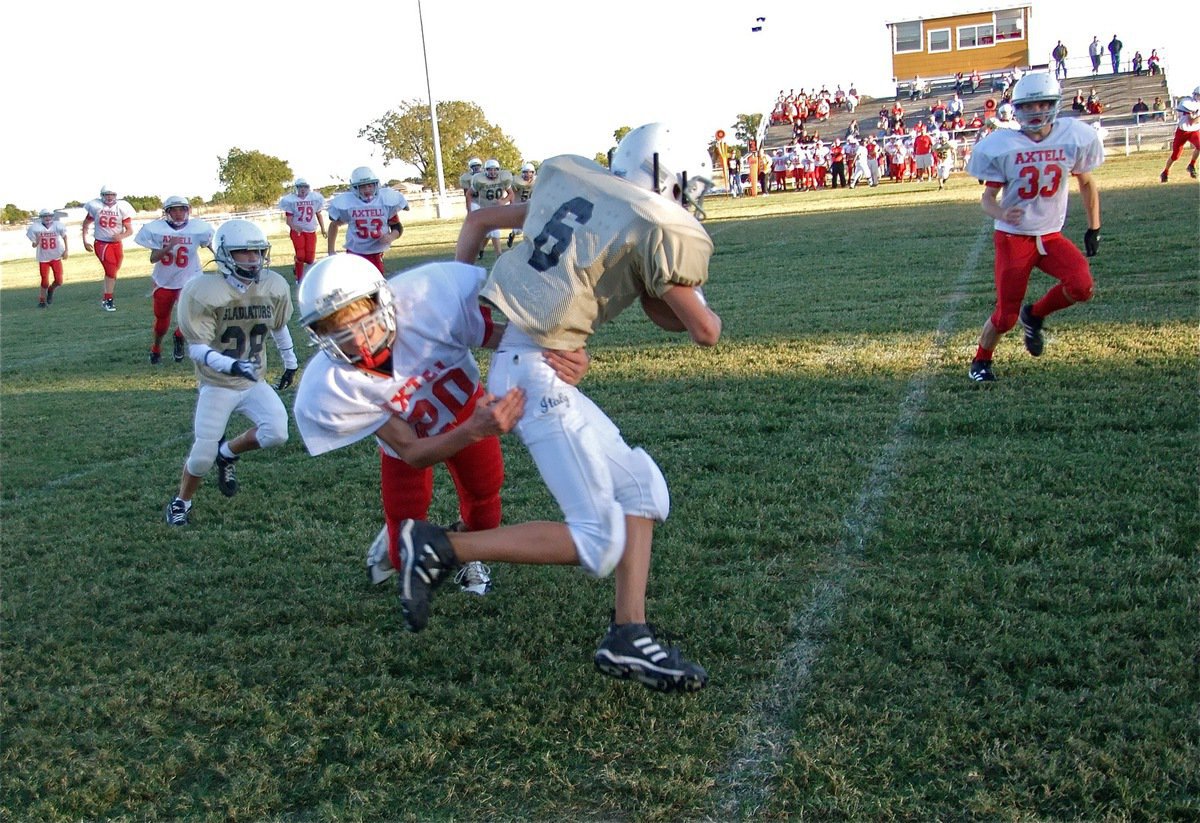 Image: Catch and run — Italy’s Colton Petrey(6) makes the catch and then gets dragged down by an Axtell tackler.