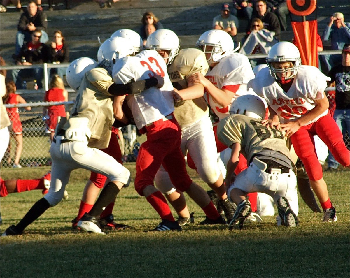 Image: Greetings — Ryan Connor(17) greets Axtell’s Dillon McBride(33) head-on at the line-of-scrimmage.