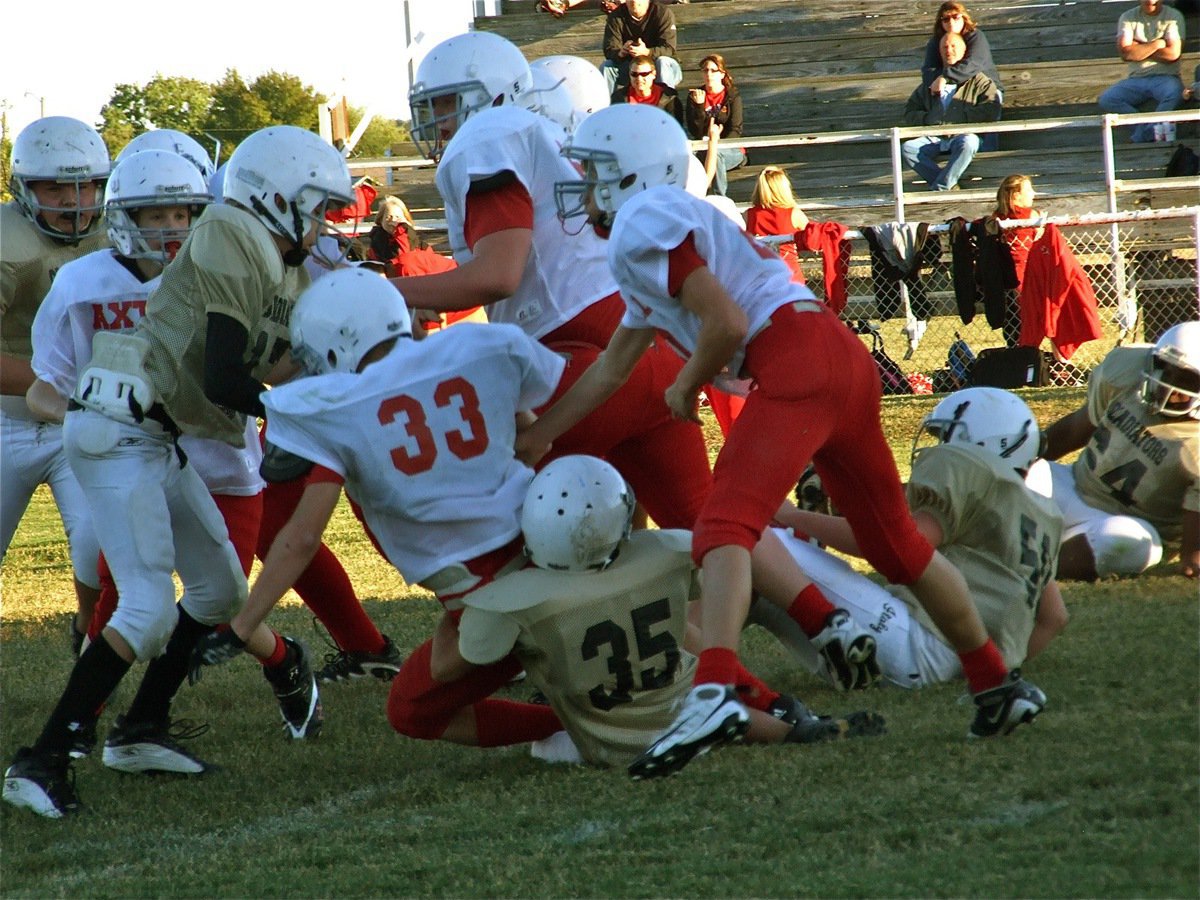 Image: The ground game — Caden Petrey(35) makes a leg tackle on Axtell’s Dillon McBride(33).