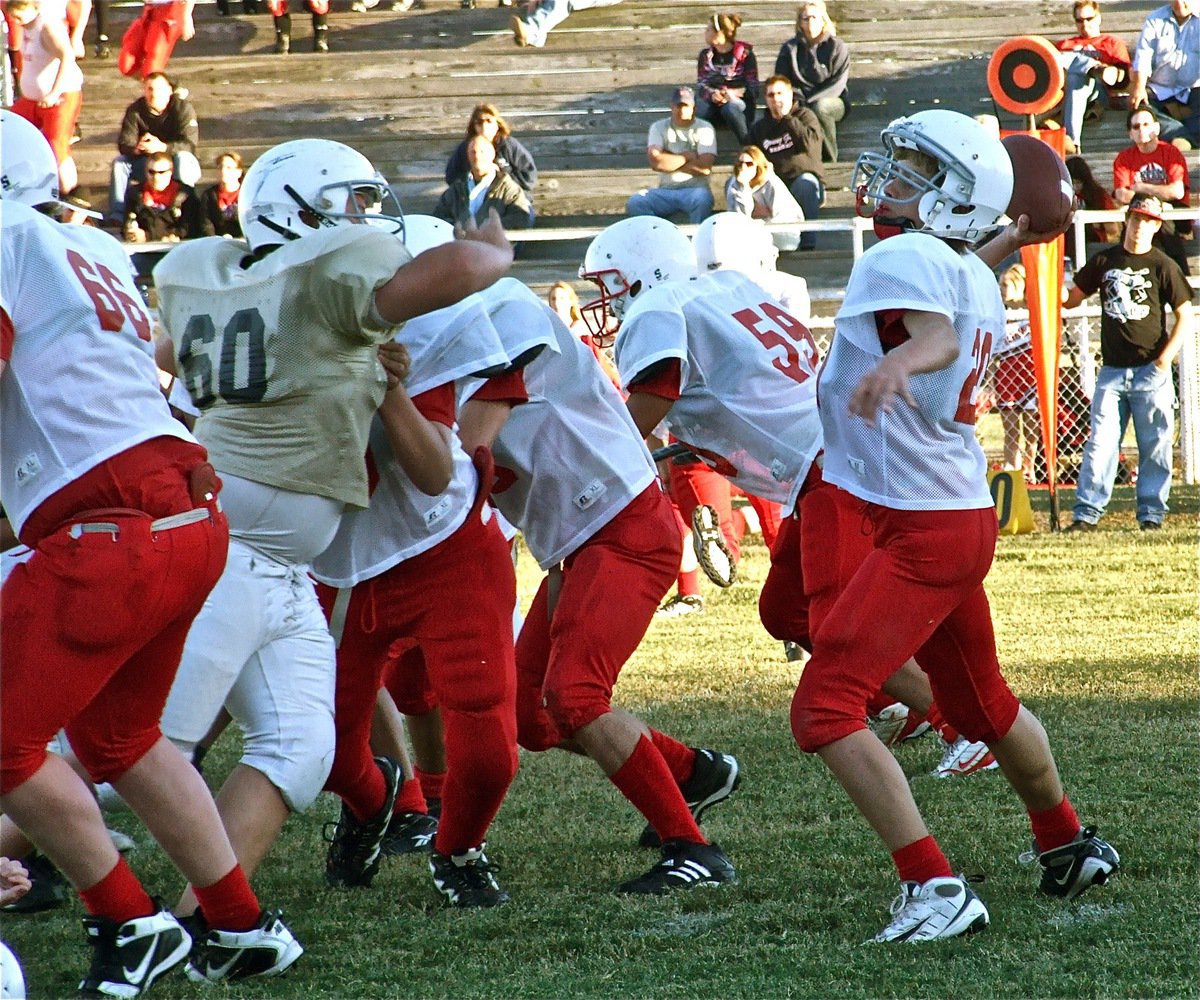 Image: Line play — Italy’s Kelton Bales(60) squeezes thru Axtell’s offensive line and knocks down the pass attempt by Longhorn quarterback Tanner Fields.