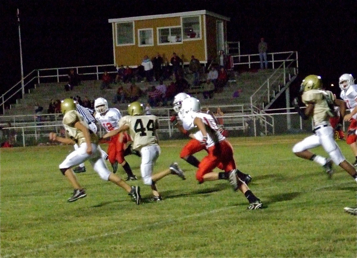 Image: Defensive stand — With Axtell threatening to score, Italy’s Justin Wood(44) catches a pass deflection then follows teammate Cody Medrano(75) toward the opposite side of the field.