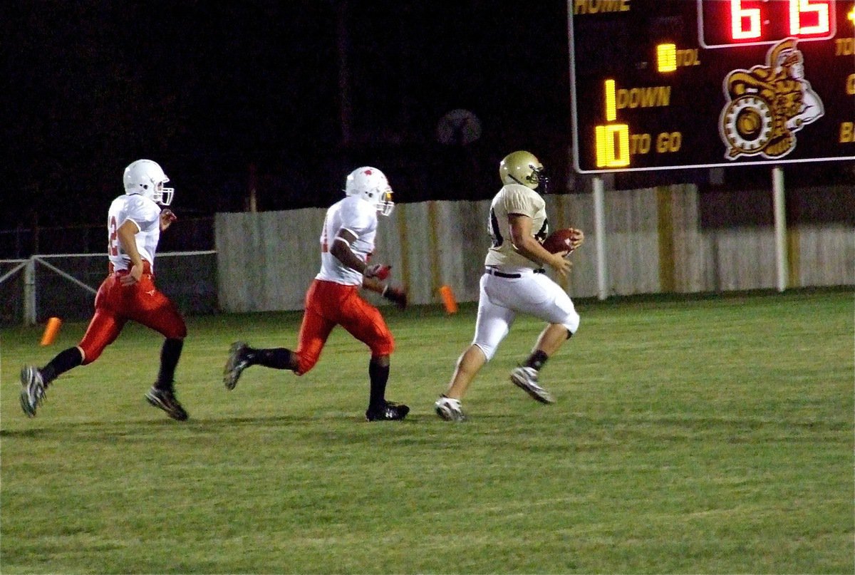 Image: Roldan rumbles — Gladiator defensive tackle Kevin Roldan(60) strips the ball from the Longhorns and sprints toward the goal line.